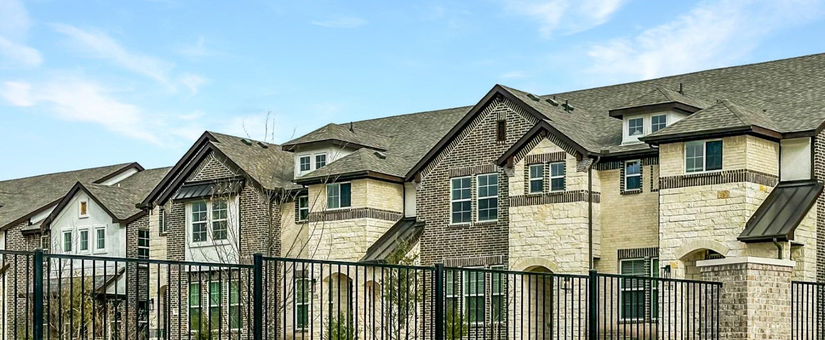 a large fence surrounds a residential neighborhood at The Villas at Bardin