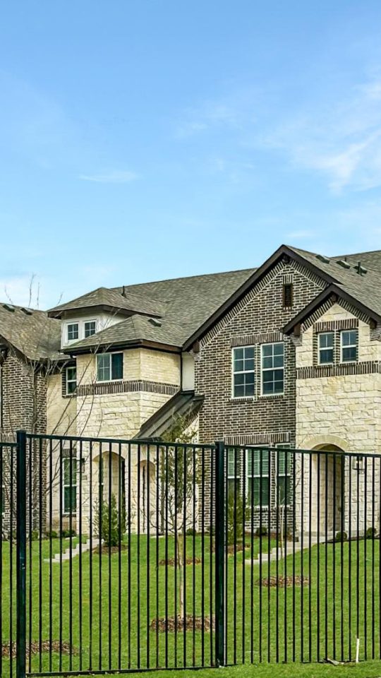 a large fence surrounds a residential neighborhood at The Villas at Bardin