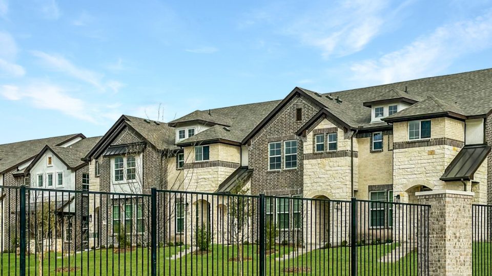 a large fence surrounds a residential neighborhood at The Villas at Bardin