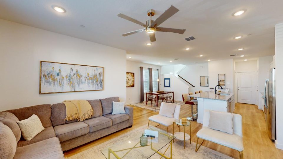 a living room with a ceiling fan and a couch at The Villas at Bardin