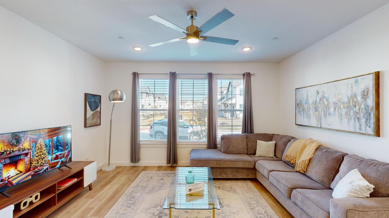 a living room with a ceiling fan and a couch at The Villas at Bardin