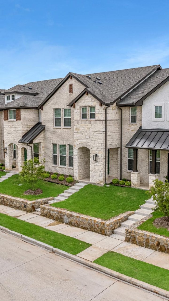 a home in the suburbs with a driveway and grass at The Villas at Bardin